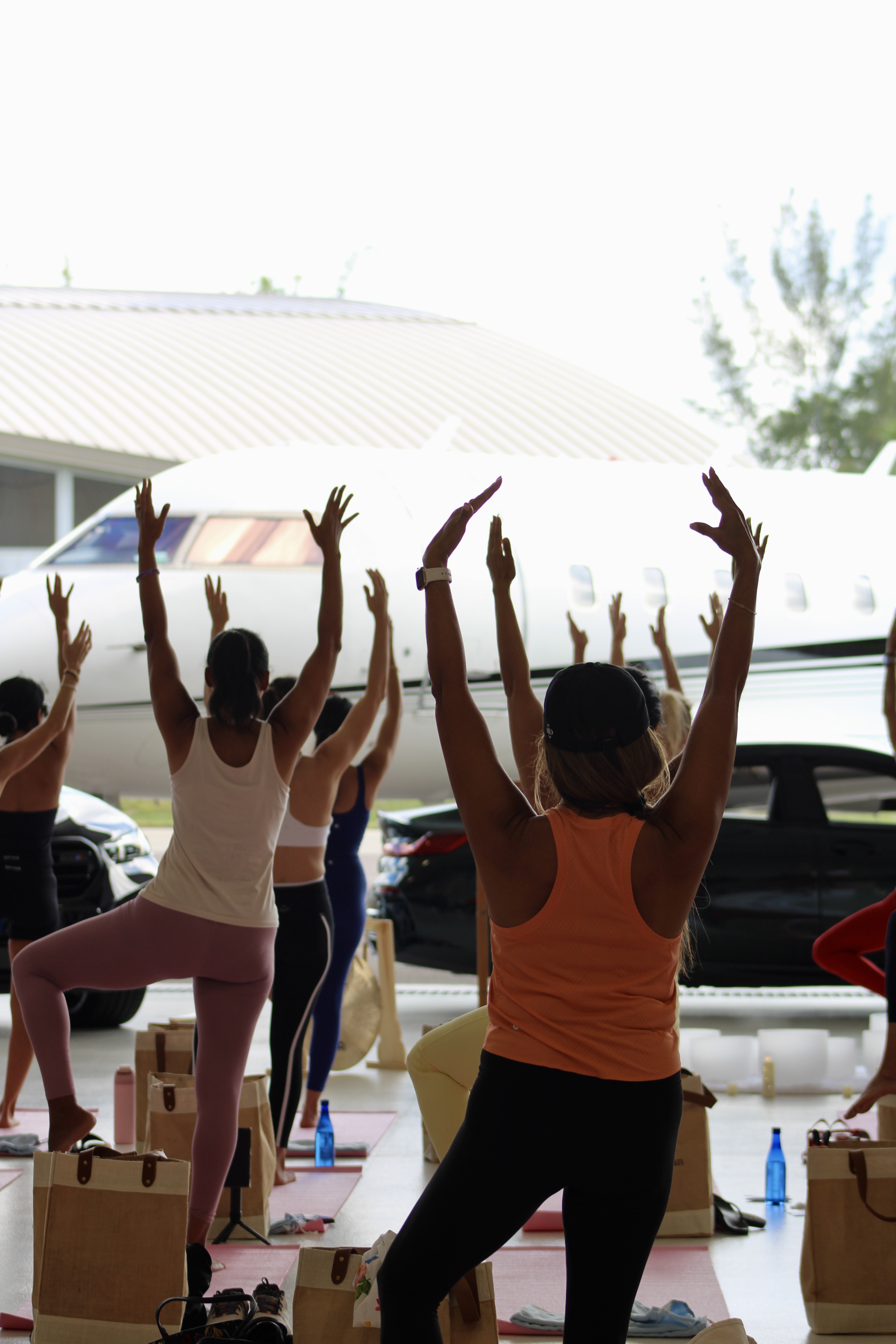 Yoga session inside a private jet hangar at Full Throttle Flow, Naples FL